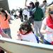 Gabriel Richard junior Mary Grace Dunleavy holds a canvas for Chelsea student Andy Ruiz-Acosta as she paints next to junior Liz Bogdan. Fr. Gabriel Richard hosted dozens of Washtenaw County Special Olympic athletes for a field day of events at the school. Melanie Maxwell I AnnArbor.com